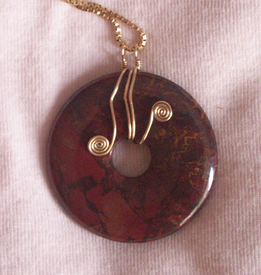 handmade mahogany obsidian donut pendant